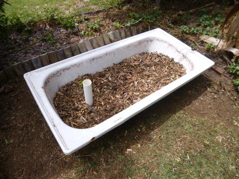 The bath set up in the front yard with wood chips in place