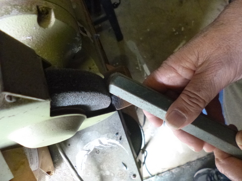 Removing mushrooming from a cold chisel using the bench grinder