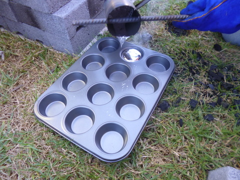 Pouring molten metal into the muffin pan