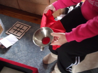 Using the jam funnel to fill a (red) pillowcase with beans