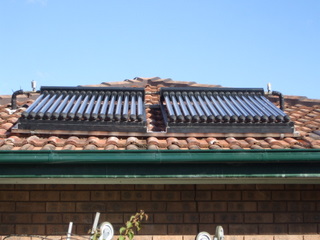 Evacuated tube solar heat collectors on roof