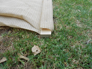 The fabric folded over and stapled