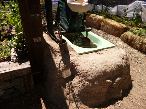 Bath heated by rocket stove